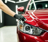 Car service worker applying nano coating on a car detail